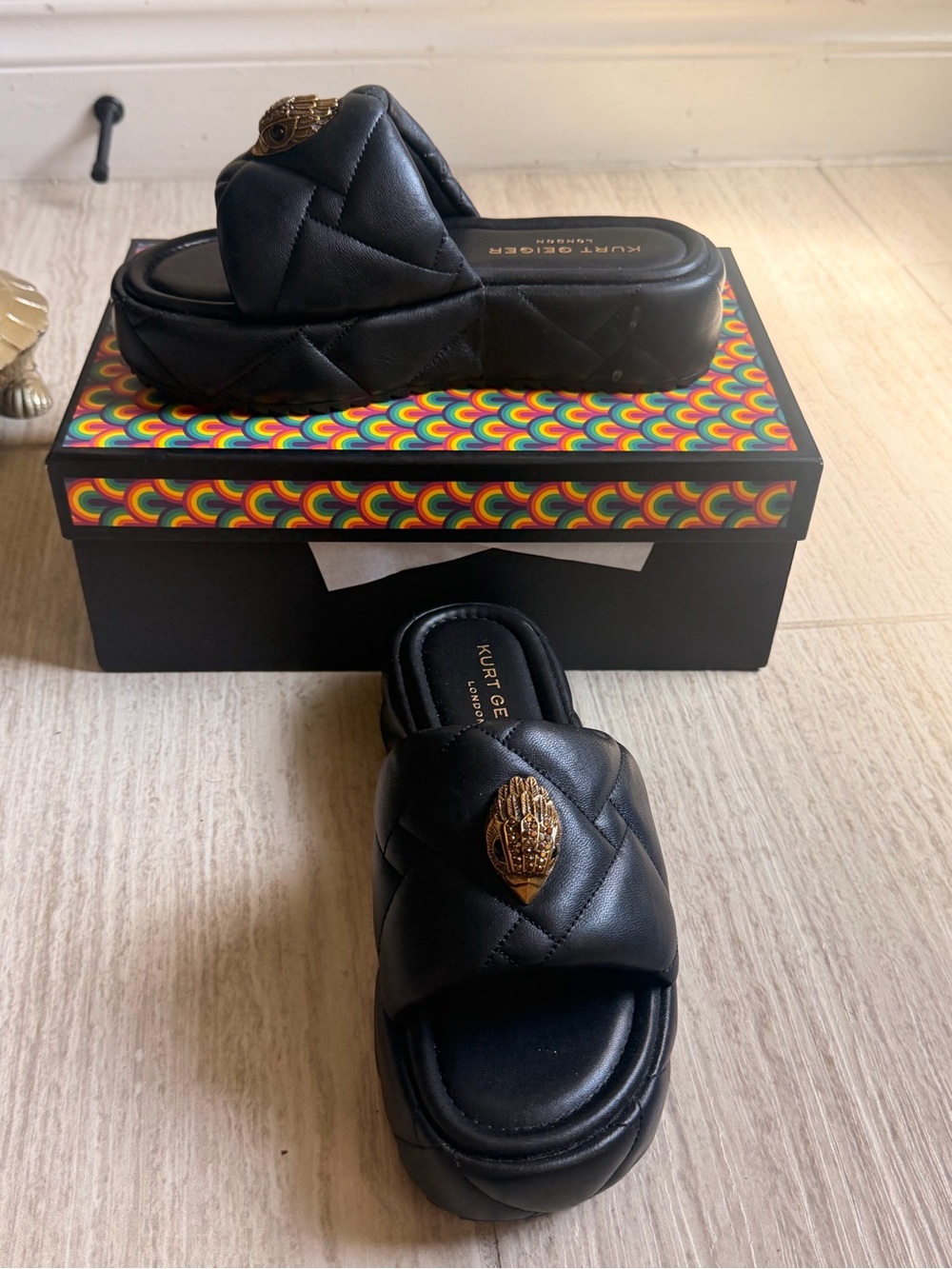 Kurt Geiger Black Quilted Slide Mules with Gold Eye Accent